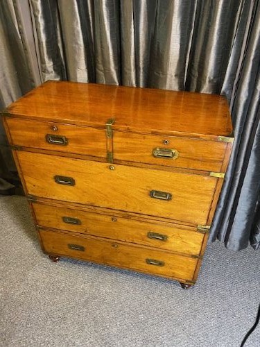 A nineteenth-century mahogany military campaign chest of drawers featuring flush brass handles, protective corner mounts, and turned feet. View IX