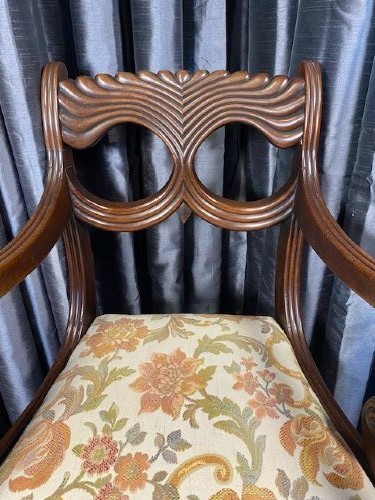 A carved mahogany carver armchair featuring reeded scroll arms, a sculpted double-circle back splat, and a floral upholstered seat. View II