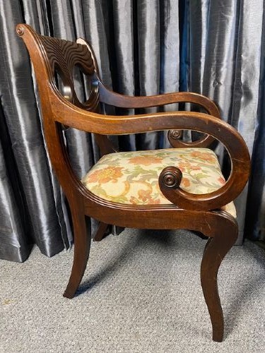 A carved mahogany carver armchair featuring reeded scroll arms, a sculpted double-circle back splat, and a floral upholstered seat. View III