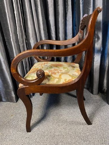 A carved mahogany carver armchair featuring reeded scroll arms, a sculpted double-circle back splat, and a floral upholstered seat. View V
