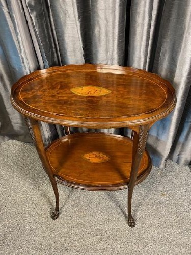 An oval two-tier mahogany occasional table featuring scalloped rims, central floral marquetry inlays, and slender cabriole legs with claw feet. View III