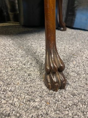 An oval two-tier mahogany occasional table featuring scalloped rims, central floral marquetry inlays, and slender cabriole legs with claw feet. View IV