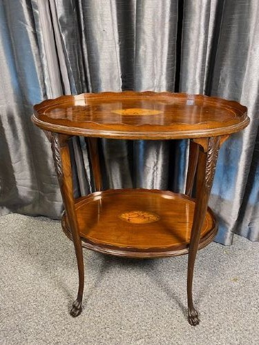 An oval two-tier mahogany occasional table featuring scalloped rims, central floral marquetry inlays, and slender cabriole legs with claw feet. View V