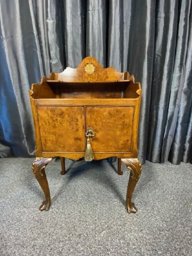 A matching pair of burr walnut bedside cabinets featuring gallery tops, twin doors, and carved cabriole legs ending in claw and ball feet. View II