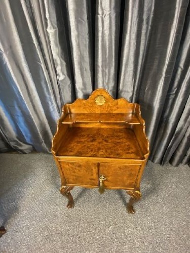 A matching pair of burr walnut bedside cabinets featuring gallery tops, twin doors, and carved cabriole legs ending in claw and ball feet. View IV