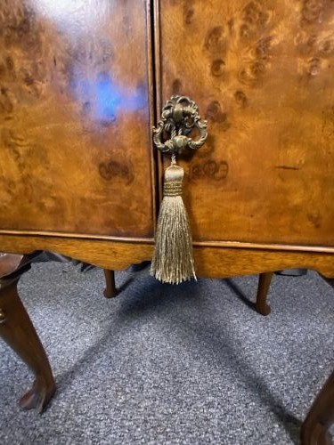 A matching pair of burr walnut bedside cabinets featuring gallery tops, twin doors, and carved cabriole legs ending in claw and ball feet. View V