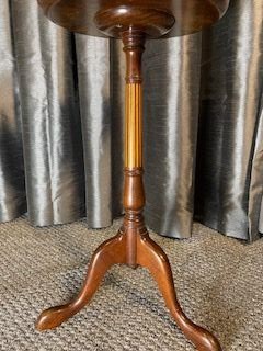 An antique warm brown mahogany wine table featuring a circular top with satinwood central inlay and a fluted turned pedestal resting on three cabriole legs. View III
