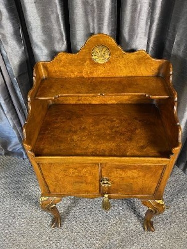 A matching pair of burr walnut bedside cabinets featuring shaped galleried shelf tops, shell carvings, double cupboard doors, and cabriole legs. View II