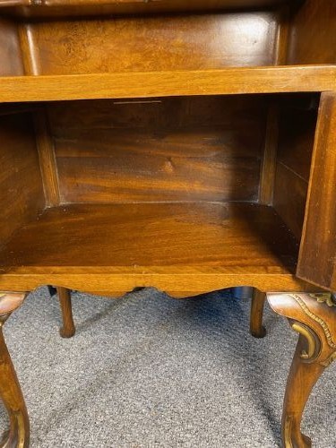 A matching pair of burr walnut bedside cabinets featuring shaped galleried shelf tops, shell carvings, double cupboard doors, and cabriole legs. View III