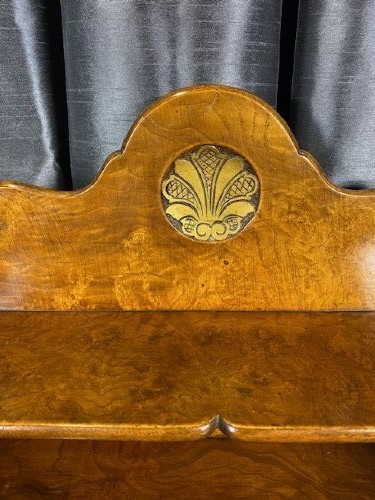 A matching pair of burr walnut bedside cabinets featuring shaped galleried shelf tops, shell carvings, double cupboard doors, and cabriole legs. View V