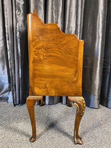A matching pair of burr walnut bedside cabinets featuring shaped galleried shelf tops, shell carvings, double cupboard doors, and cabriole legs. View VII
