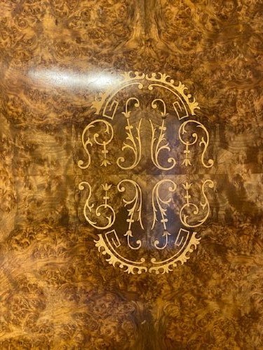 An oval burr walnut coffee table featuring floral marquetry inlay, a moulded rim, and carved splayed legs. View V