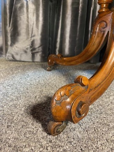 An oval burr walnut coffee table featuring floral marquetry inlay, a moulded rim, and carved splayed legs. View VIII