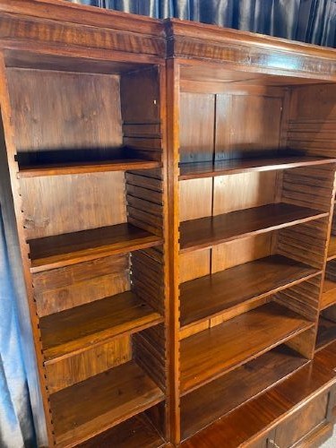A large Victorian mahogany open breakfront bookcase featuring three sectioned shelving units over a low plinth cabinet base. View III