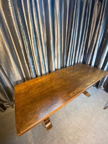 A solid oak refectory dining table featuring a rectangular plank top supported by a sturdy trestle base with a central stretcher rail. View II