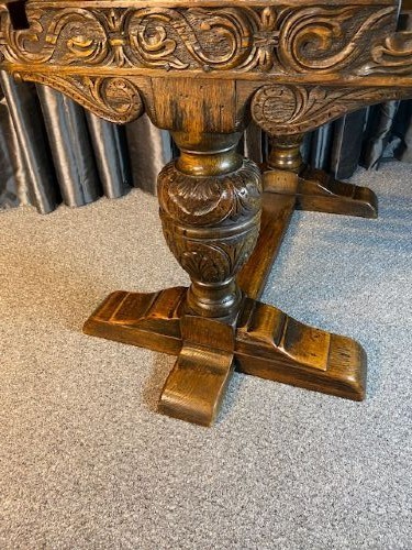 A dark oak draw-leaf dining table featuring extended side leaves, heavy carved bulbous legs, and a sturdy central stretcher. View IV
