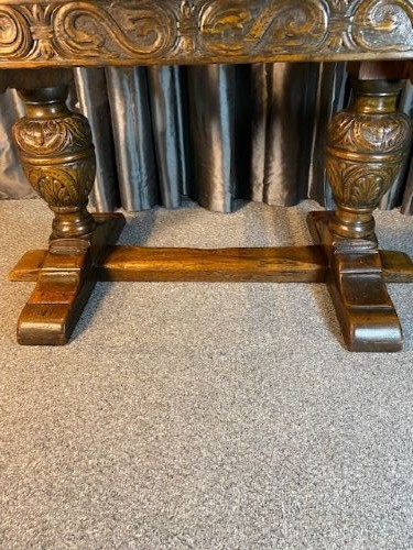A dark oak draw-leaf dining table featuring extended side leaves, heavy carved bulbous legs, and a sturdy central stretcher. View VI