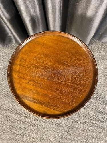A circular mahogany wine table featuring a moulded dished top, a turned baluster stem, and a three-legged cabriole tripod base. View II
