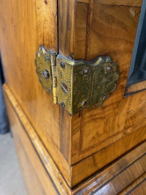 An antique walnut bureau bookcase featuring a broken arch pediment, double mirrored cabinet doors, a slant-front writing slope, and several drawers with brass handles. View VII