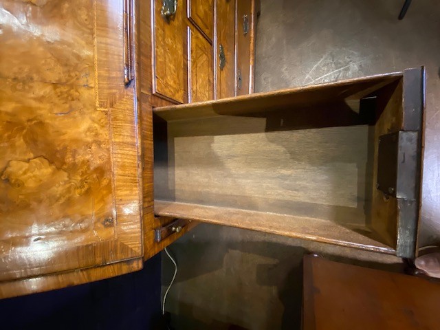 An antique walnut bureau bookcase featuring a broken arch pediment, double mirrored cabinet doors, a slant-front writing slope, and several drawers with brass handles. View XI
