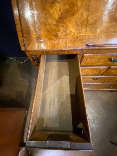 An antique walnut bureau bookcase featuring a broken arch pediment, double mirrored cabinet doors, a slant-front writing slope, and several drawers with brass handles. View XI