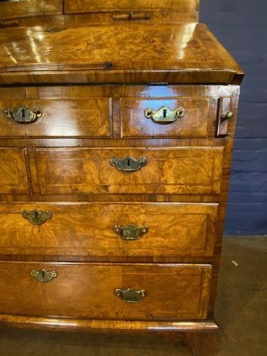 An antique walnut bureau bookcase featuring a broken arch pediment, double mirrored cabinet doors, a slant-front writing slope, and several drawers with brass handles. View XII