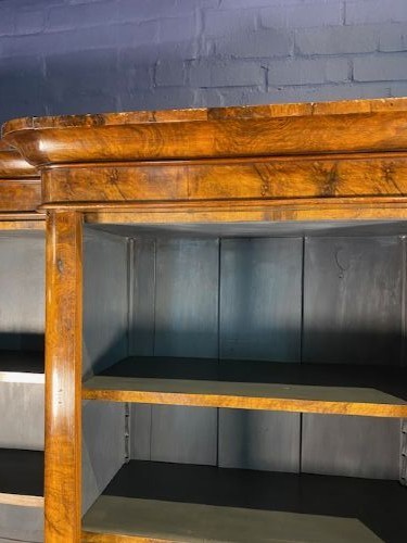A large Victorian burr walnut breakfront bookcase featuring open adjustable shelves and a dark painted interior. View II