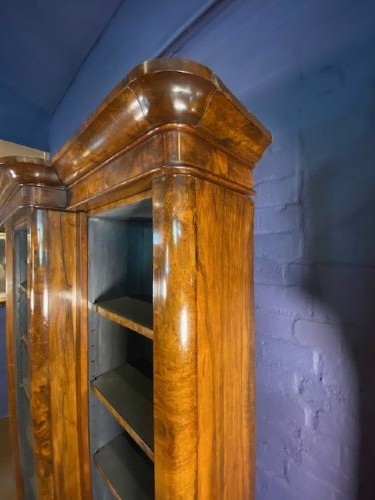 A large Victorian burr walnut breakfront bookcase featuring open adjustable shelves and a dark painted interior. View III