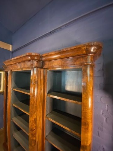 A large Victorian burr walnut breakfront bookcase featuring open adjustable shelves and a dark painted interior. View IV