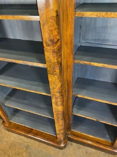A large Victorian burr walnut breakfront bookcase featuring open adjustable shelves and a dark painted interior. View VI