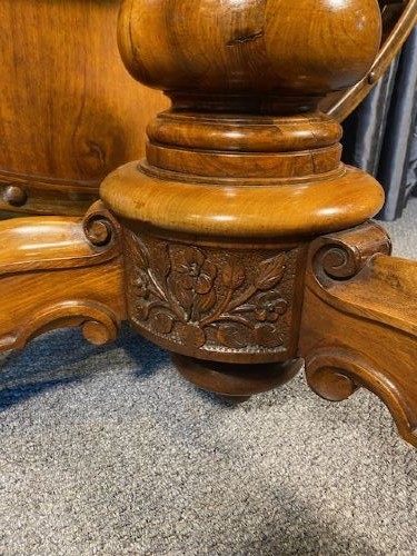 A circular Victorian burr walnut tilt-top table displaying book-matched veneer figure, supported by a carved tripod pedestal base. View VII