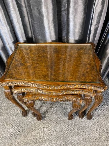 A set of three graduated walnut nesting tables featuring glass tops, shell carvings on the frieze, and cabriole legs. View II