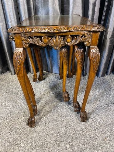 A set of three graduated walnut nesting tables featuring glass tops, shell carvings on the frieze, and cabriole legs. View III