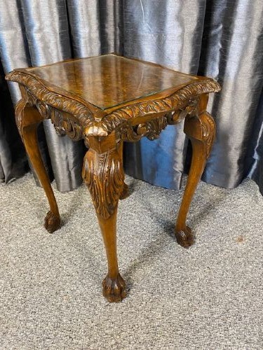 A set of three graduated walnut nesting tables featuring glass tops, shell carvings on the frieze, and cabriole legs. View V