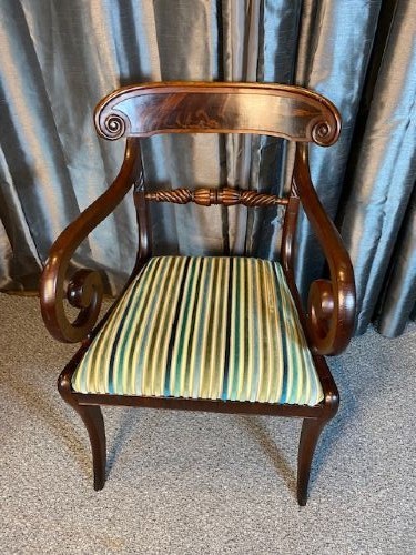 A pair of antique Regency mahogany carver chairs featuring curved scroll arms, carved crossbars, striped fabric upholstered seats, and sabre legs. View III