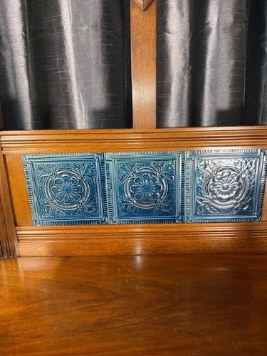 A tall walnut hall stand featuring a top scrolled crest, brass hooks, a diamond-shaped central mirror, blue ceramic tiles, a glove drawer, and umbrella holders with drip trays. View IV