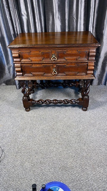 A dark oak side table featuring two drawers with geometric mouldings, brass teardrop handles, barley twist legs, and matching lower stretchers. View II