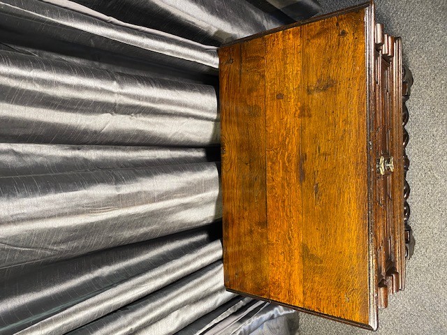 A dark oak side table featuring two drawers with geometric mouldings, brass teardrop handles, barley twist legs, and matching lower stretchers. View VI