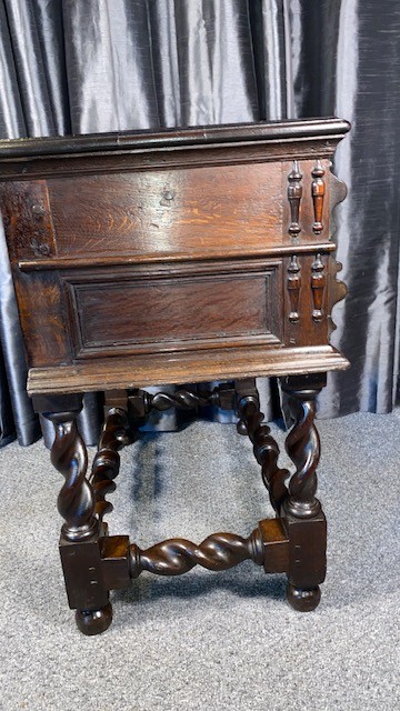A dark oak side table featuring two drawers with geometric mouldings, brass teardrop handles, barley twist legs, and matching lower stretchers. View VII