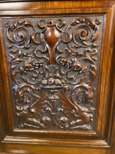 A tall Victorian walnut bookcase featuring a two-door glazed upper display section, two middle drawers with metal handles, and carved panel doors at the base. View II