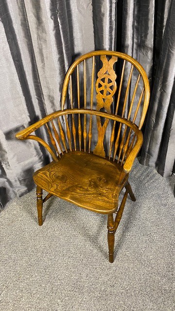 A set of six brown wooden Windsor dining chairs with hoop backs, pierced wheelback central splats, and turned legs. View VI