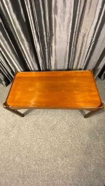 A low rectangular mahogany coffee table featuring a raised gallery rim and decorative pierced fretwork corner brackets on square legs. View III