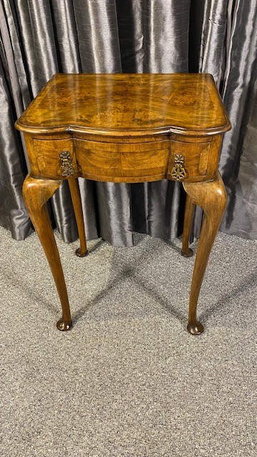 A Queen Anne style walnut occasional table featuring slender cabriole legs, pad feet, and a single drawer fitted with two ornate brass drop handles. View II