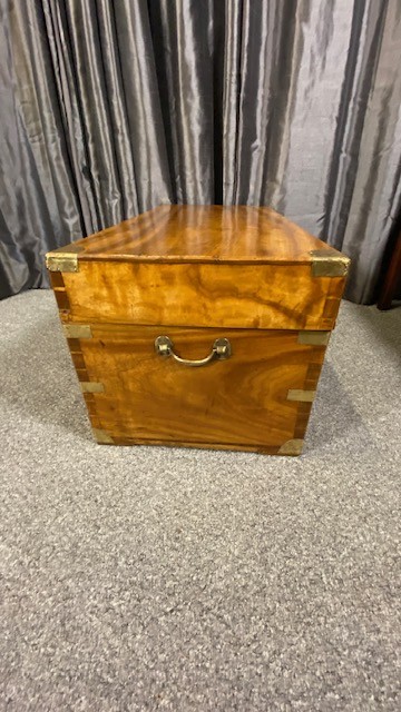 A rectangular camphor wood military campaign chest featuring brass corner brackets, flush brass handles, and a central brass keyhole escutcheon. View III