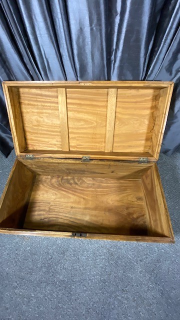 A rectangular camphor wood military campaign chest featuring brass corner brackets, flush brass handles, and a central brass keyhole escutcheon. View VI