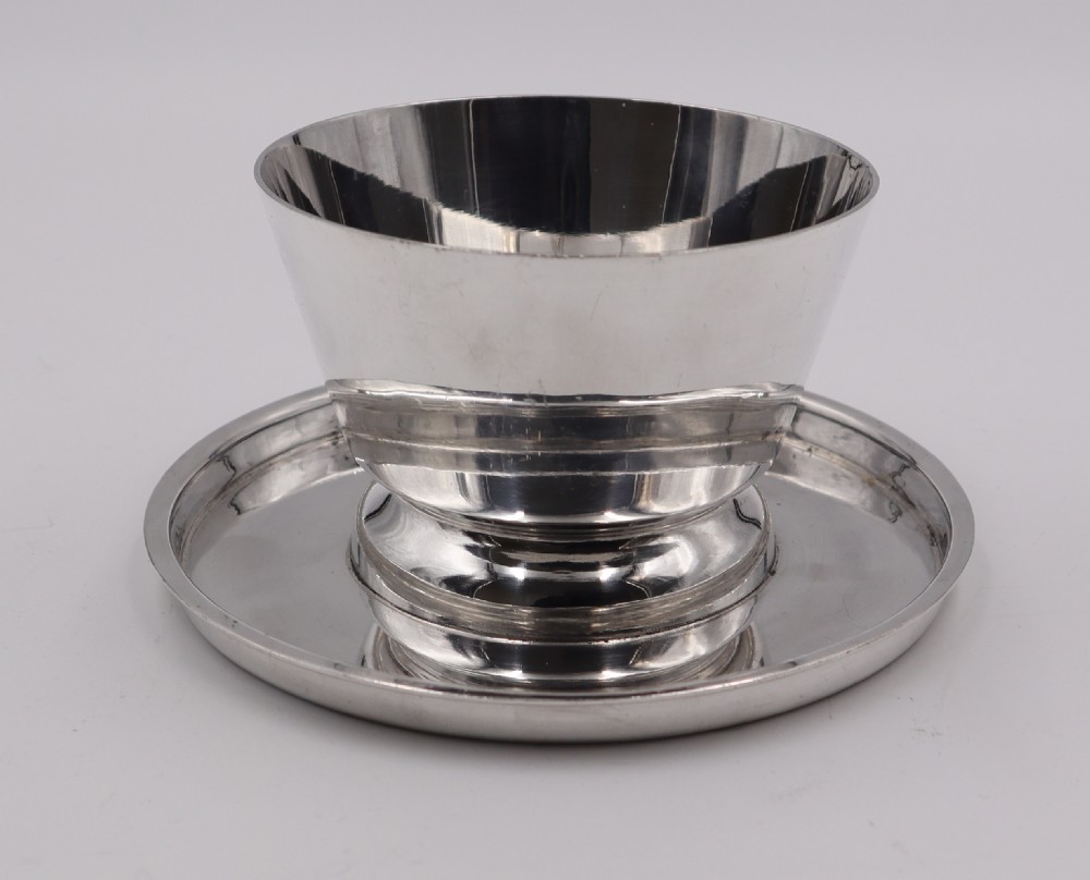 A set of four silverplated Art Deco dessert dishes featuring flared rims, stepped bases, and matching circular saucers. View IV