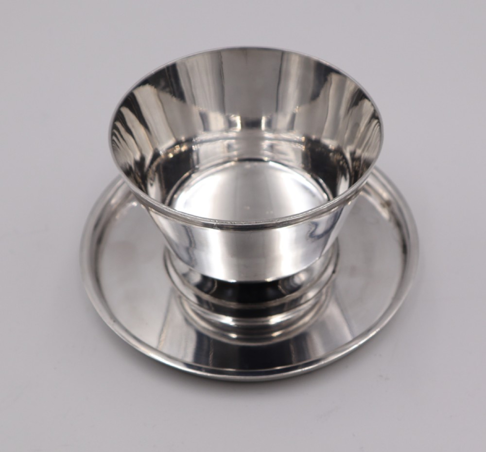 A set of four silverplated Art Deco dessert dishes featuring flared rims, stepped bases, and matching circular saucers. View V