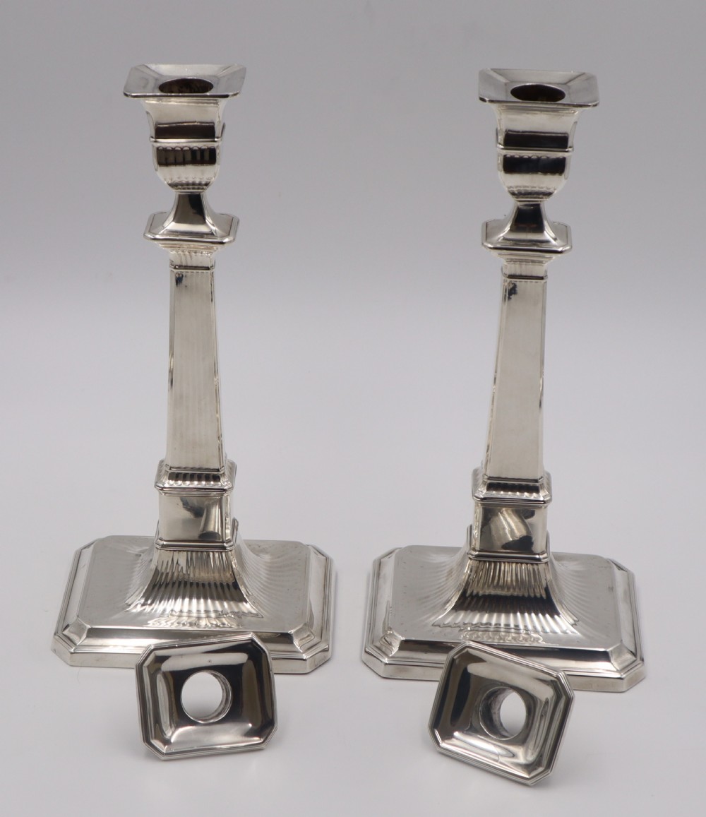 A pair of antique sterling silver candlesticks featuring fluted column shafts and square stepped bases. View III