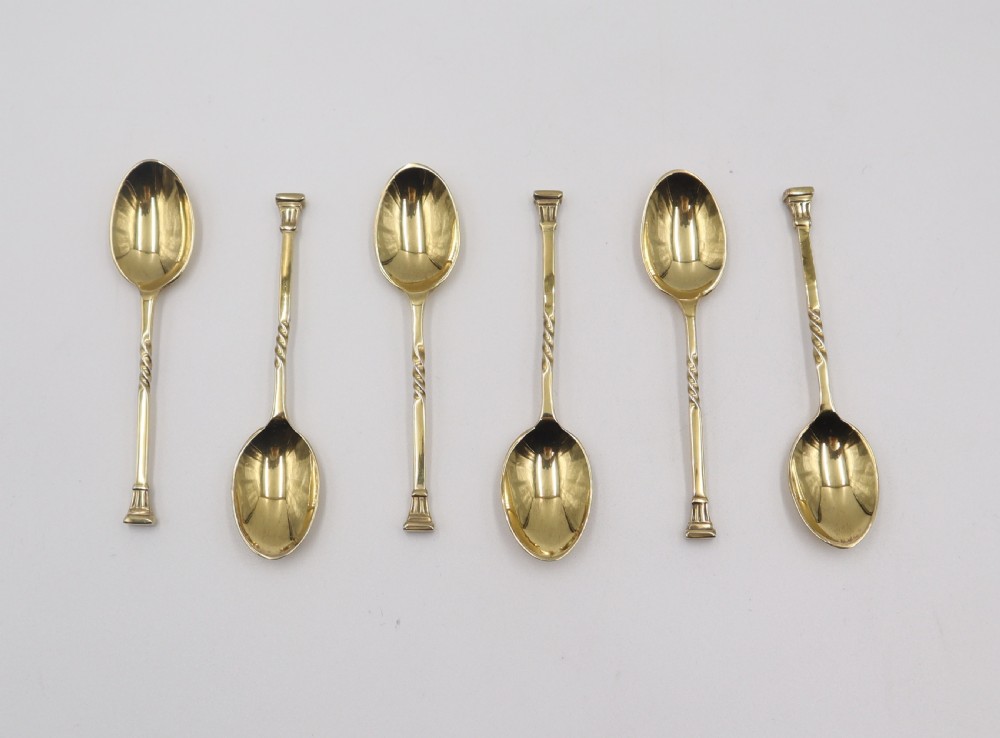 A set of six silver-gilt spoons with twisted stems displayed inside a fitted black presentation case lined with cream silk and black velvet. View III