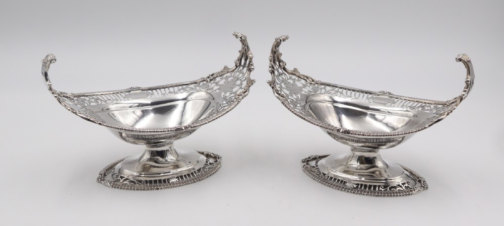 A pair of antique boat-shaped silver sweetmeat stands featuring pierced openwork borders and pedestal bases. View II
